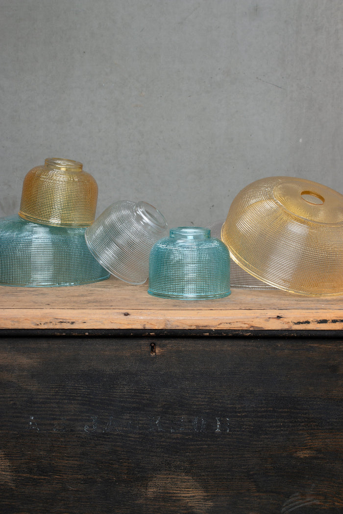 Varying small and large holophane style shades in different finishes