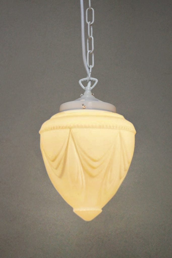 glass pendant light with white chain cord.