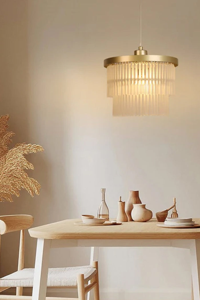 1 light, 2 teir glass rod chandelier over a dining space.