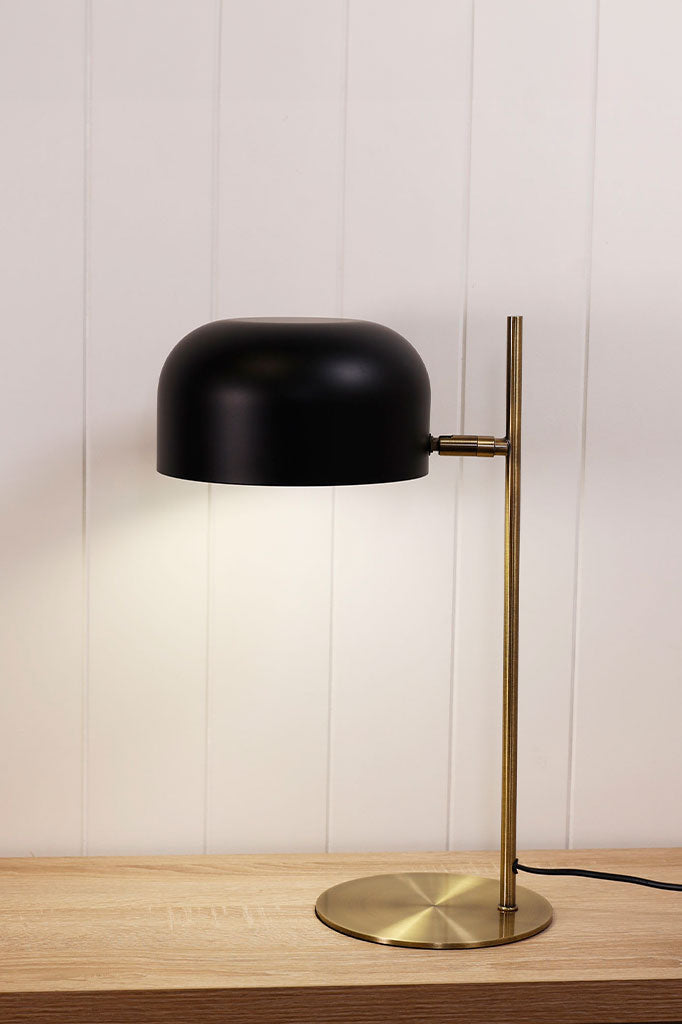 Table lamp with brass finish and black shade