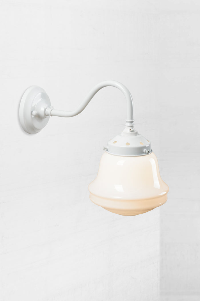 White gooseneck wall sconce with an opal schoolhouse style shade.