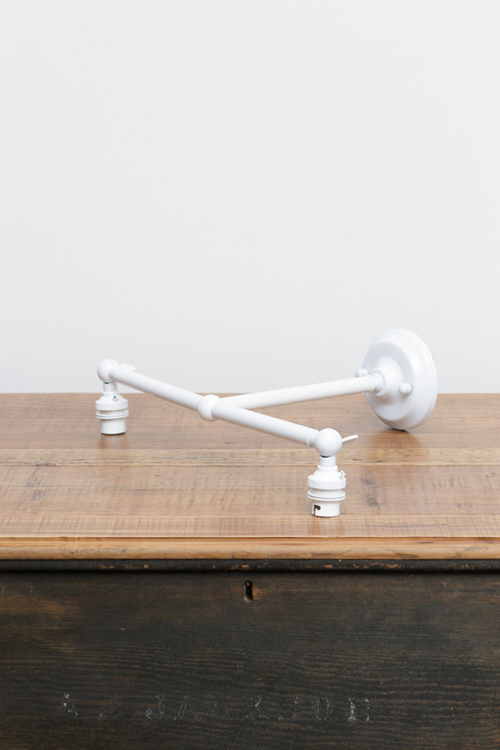 White finished double swivel lampholder wall sconce.