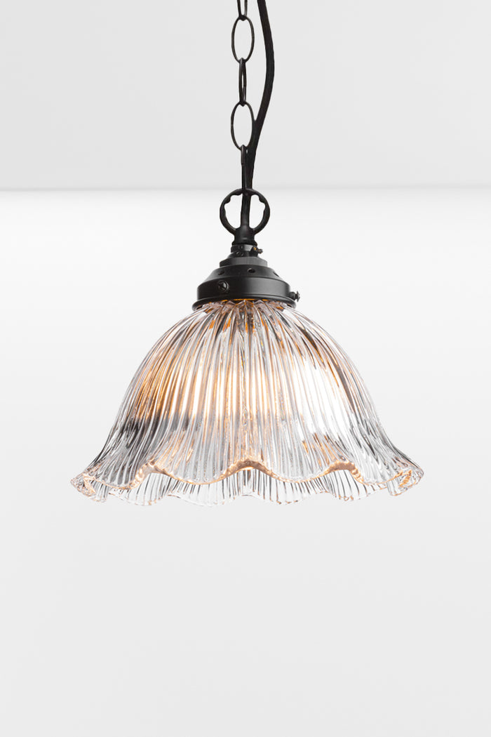 Large frill como shade with black chain/cord suspension.