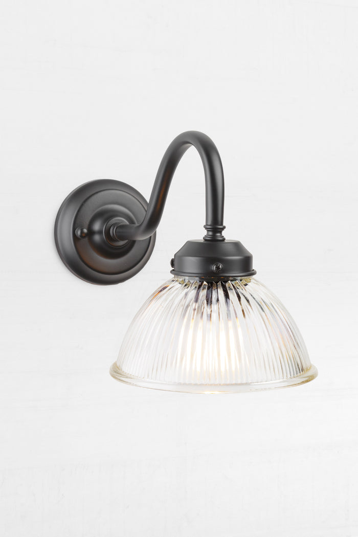 Level view of the black outdoor gooseneck wall light with a clear ribbed shade.