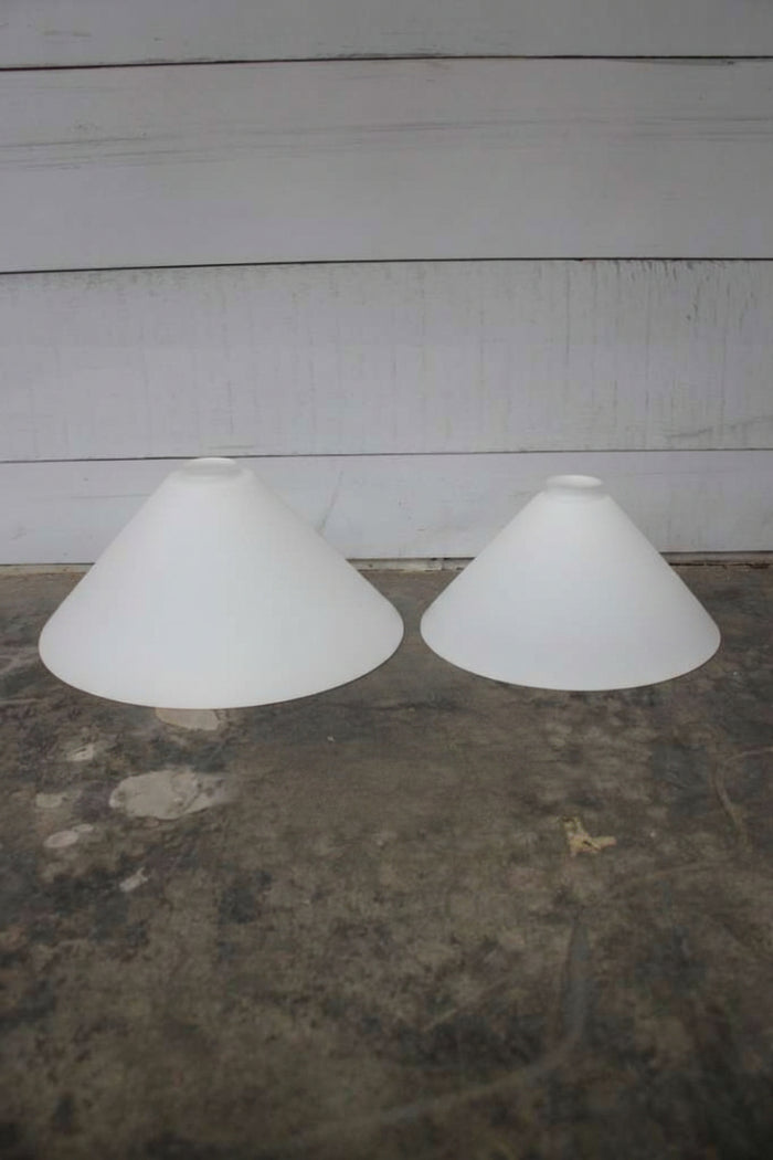 Medium and large opal glass conical shades.