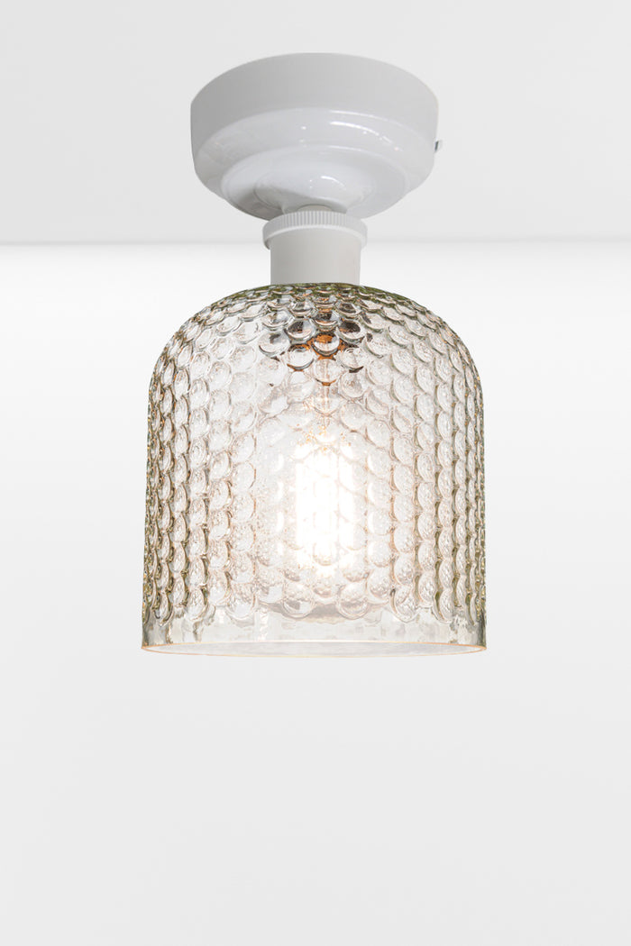 Clear dimpled glass shade with a white batten holder.