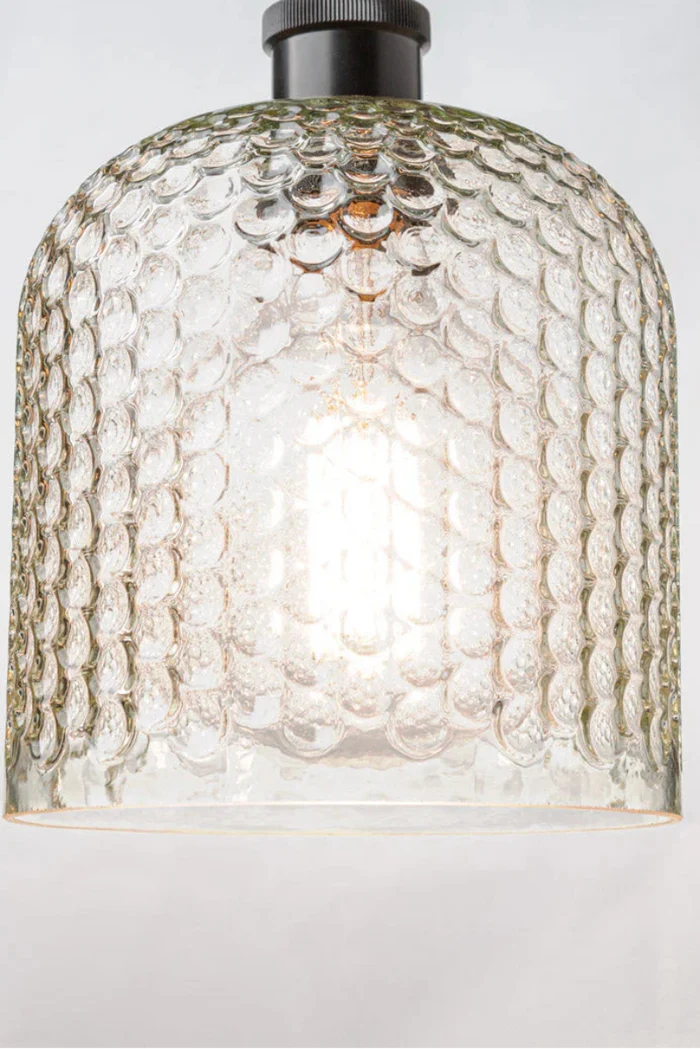 glass shade offers a dimpled texture and on a black flush mount