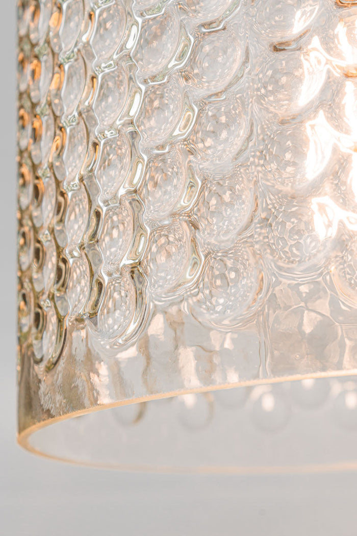 Close up of the bottom edge of the dimpled clear glass shade.