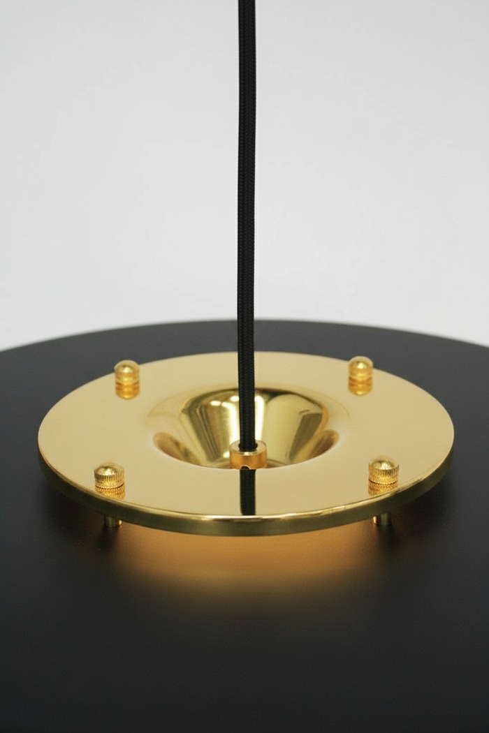 Gold/brass metalware with black pendant cord