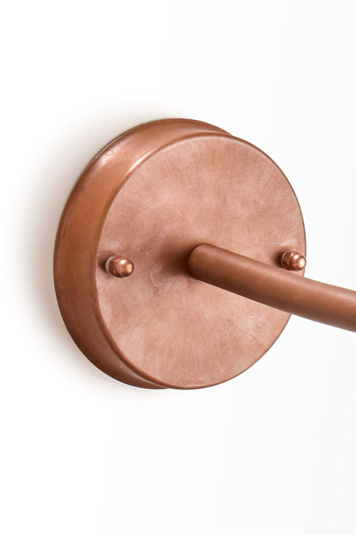 Close up of the wall mount on the copper wall light.