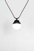glass ball shades shown on a black trapeze pendant cord.