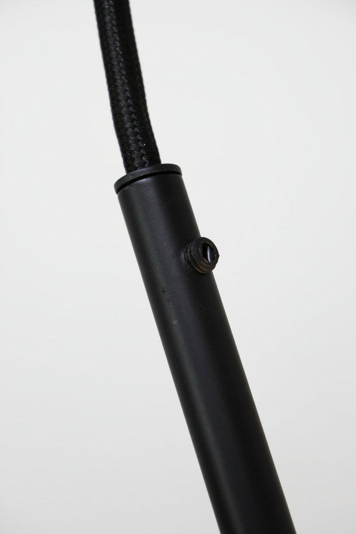 Close of of join between black braided cord and u shaped tube.