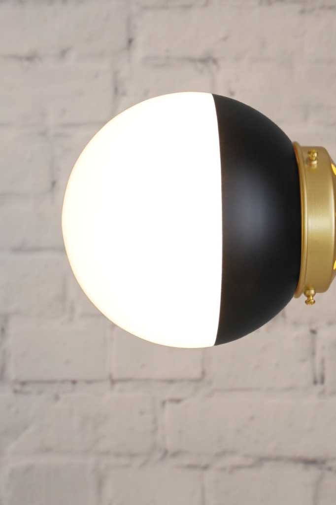 Crown Sphere Light with a gold gallery and a black and opal shade