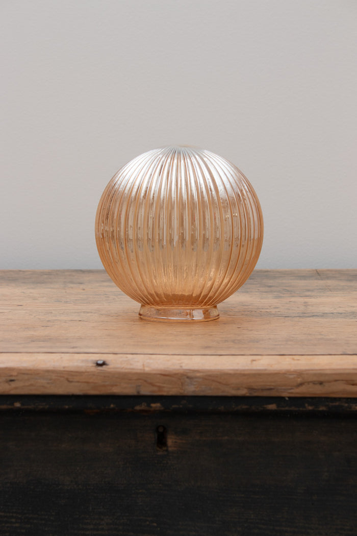 Dakota Reeded Glass Shades in dark amber on a timber bench.