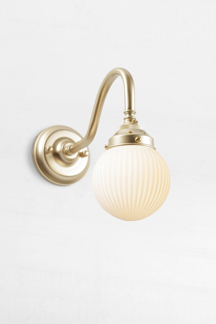 Gold/brass gooseneck wall sconce with an opal reeded glass ball shade.
