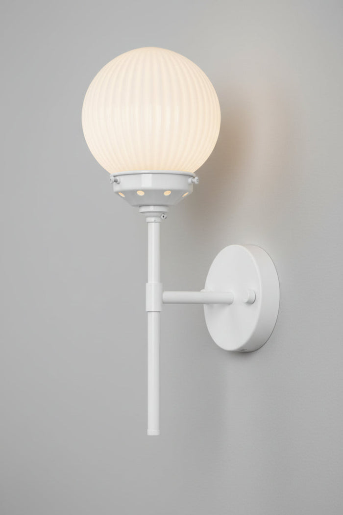 White stem wall sconce paired with an opal reeded glass ball shade.