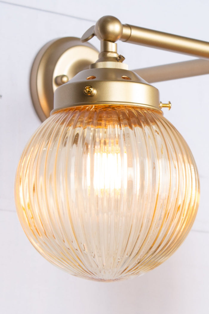 amber reeded glass ball shades- on gold brass wall sconce