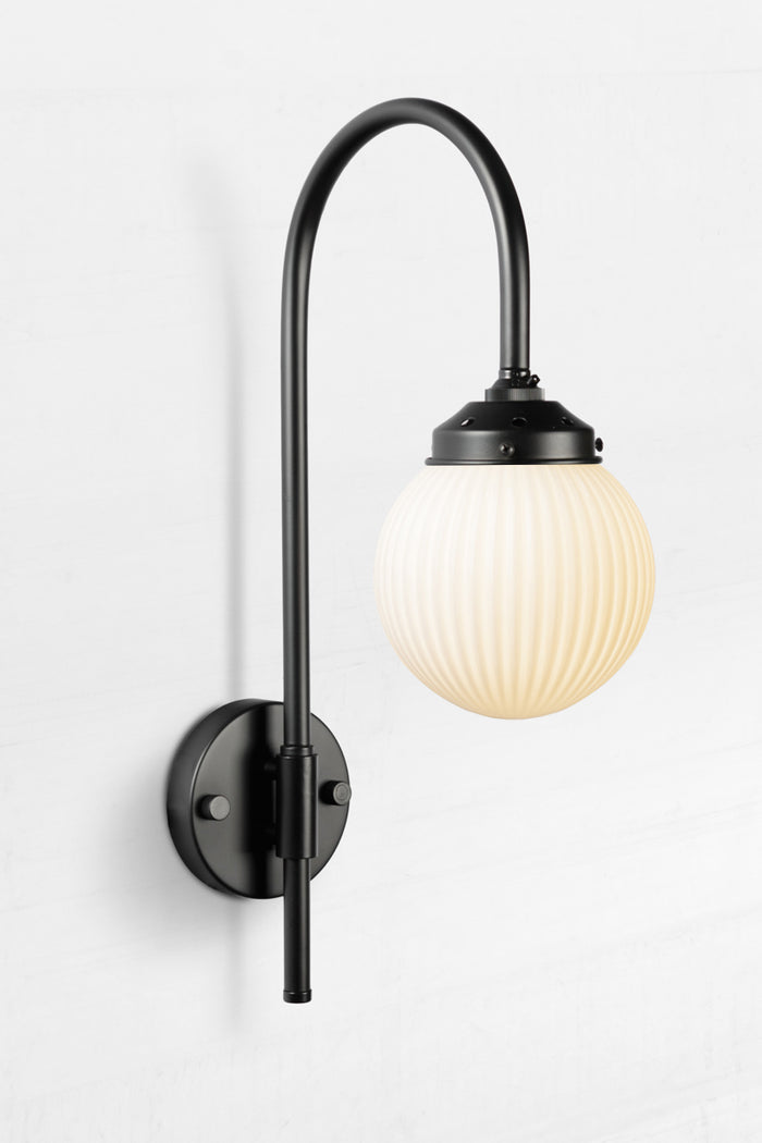 Shepard gooseneck wall light in black with a opal reeded glass ball shade.