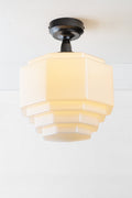 Opal glass teired shade on a black batten holder