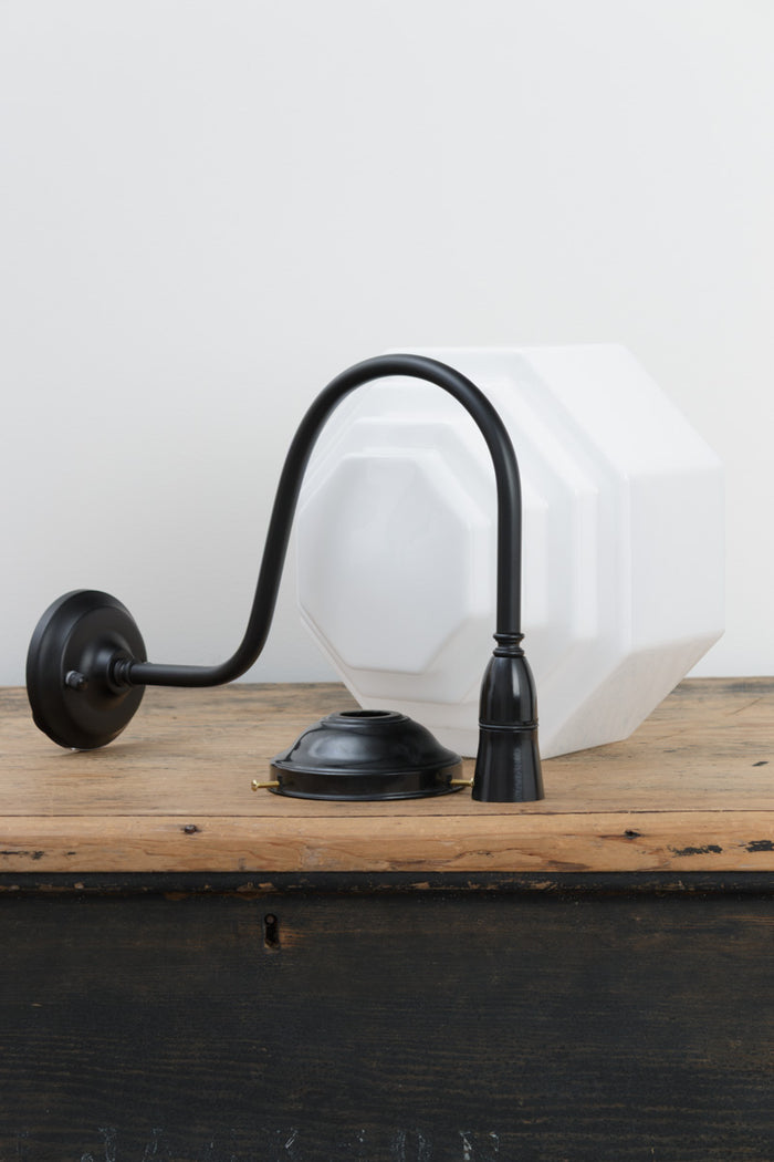 Uninstalled oversized black gooseneck wall arm with a bakelite gallery and a stepped opal glass shade.