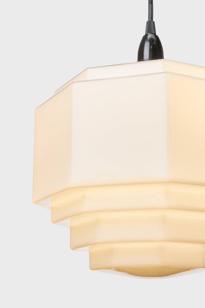 close up of opal glass shade with elegant silhouette constructed from artisanal hand blown glass