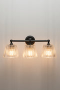 Black Davis Glass Triple Swivel Arm Wall Light with three tapered clear fluted glass shades