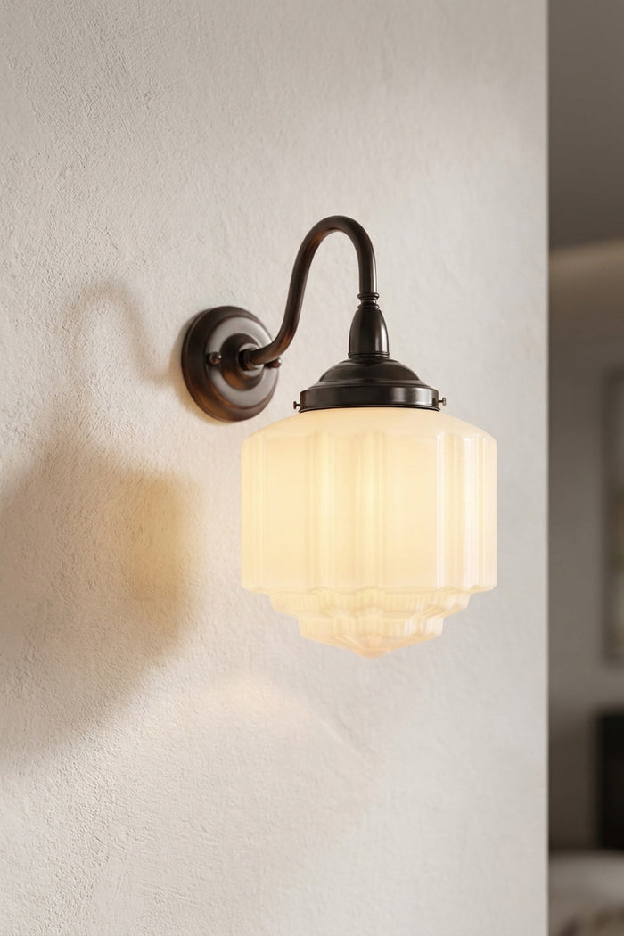 Deco Glass Exterior Wall Light with glowing opal shade against neutral exterior wall