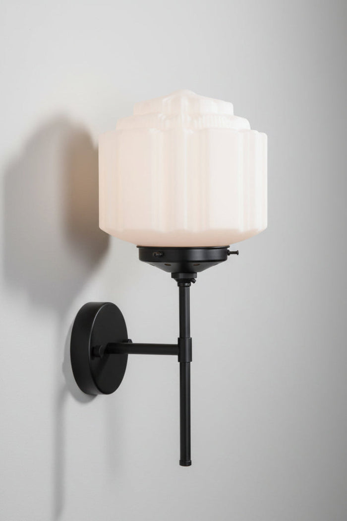 Side view of the Deco opal glass shade paired with a black wall stem sconce.