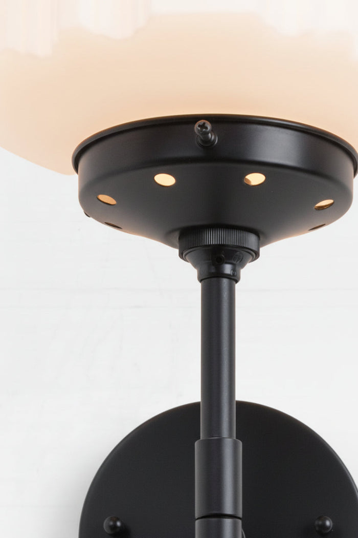 Close up of the black stem wall light, gallery and opal glass Deco shade.