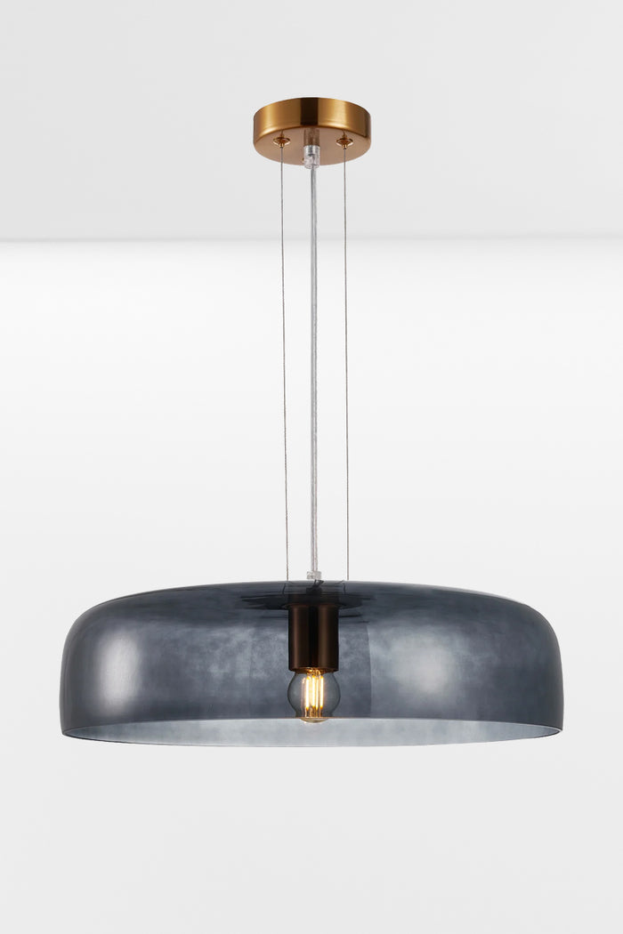 Single tiered smokey black glass pendant light with the light on.