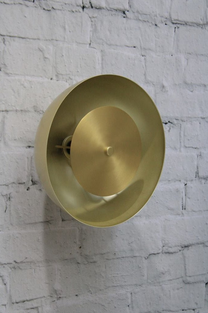 Dome wall light with gold/brass shade and gold/brass disc