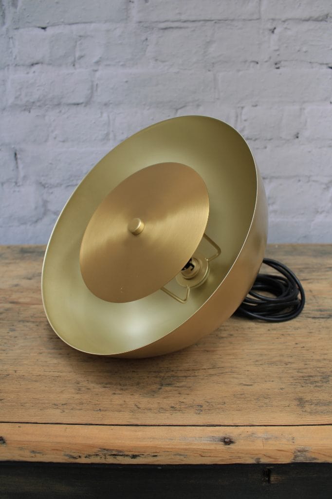 Gold/brass dome wall light with brass disc