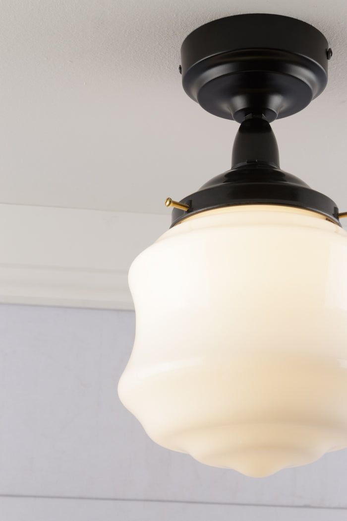 Showing matt black battenholder IP rated with a opel schoolhouse shade.