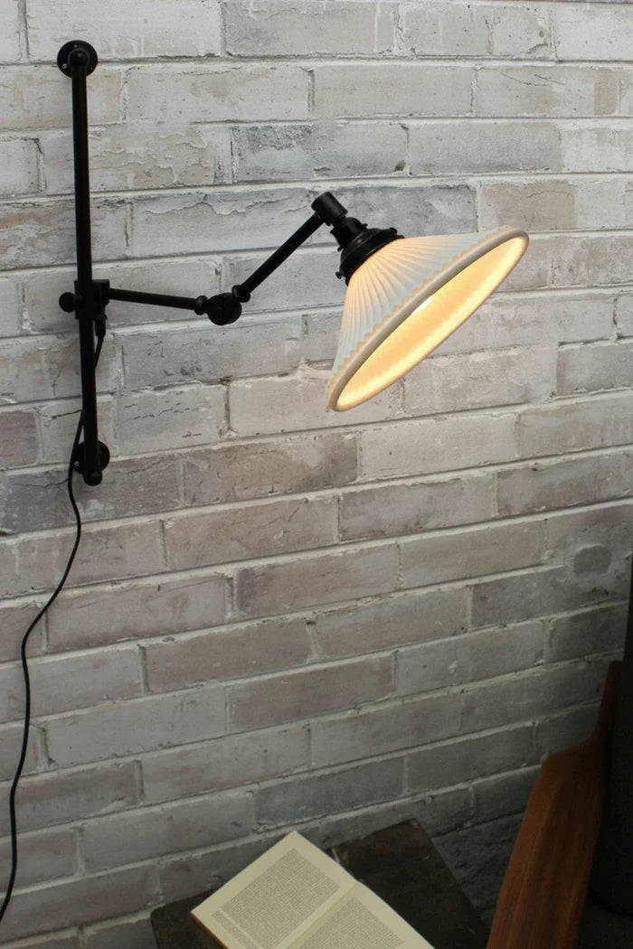 Swing arm wall light with ceramic shade and wall plug