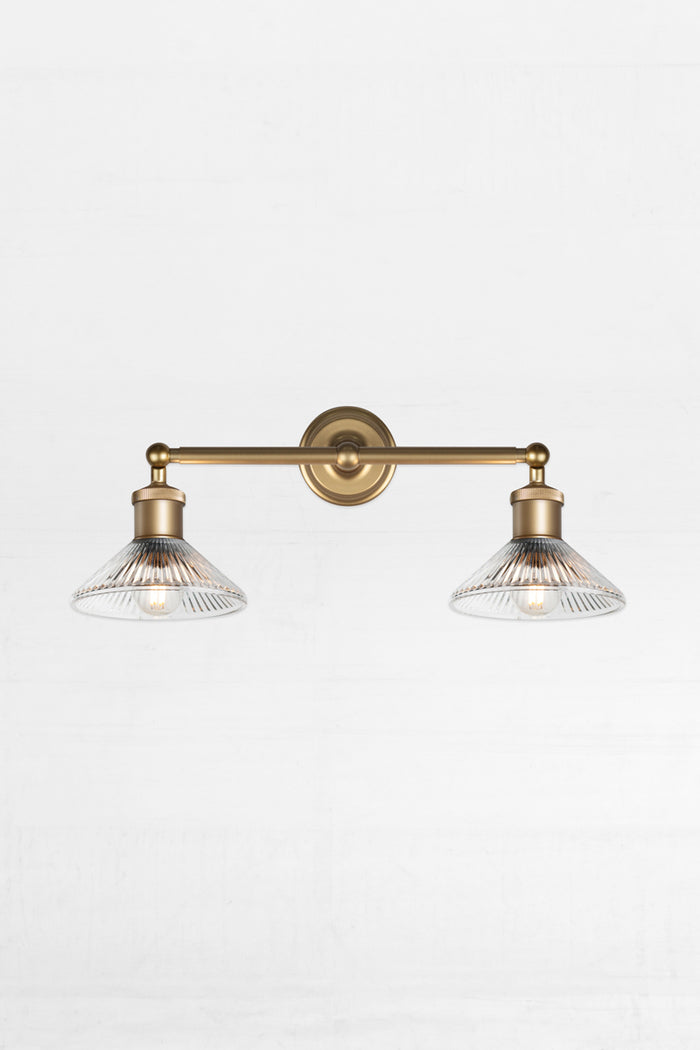 Gold/brass double Swivel Wall Sconce with two clear pleated shades.