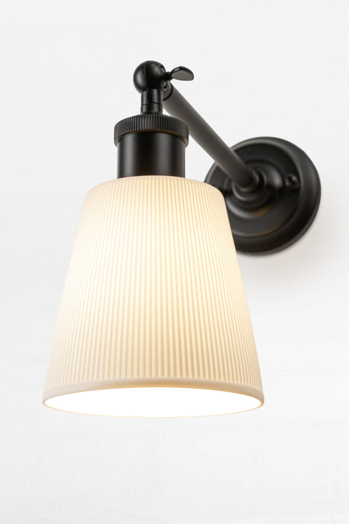 Close up of the large ceramic shade on the outdoor wall sconce