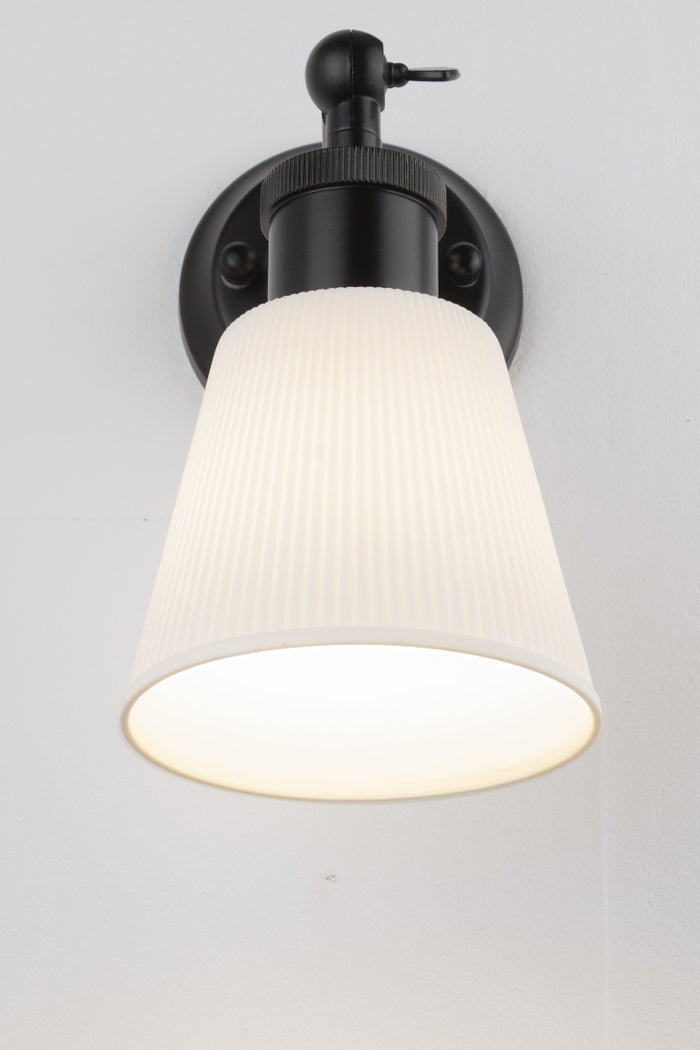 Small ceramic shade on short swivel straight arm wall sconce.