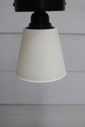 Ceiling light with black base and small ceramic shade