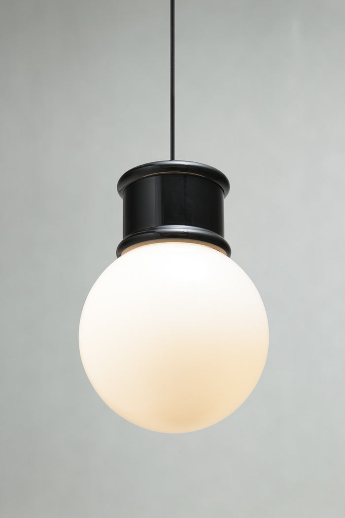 Medium opal glass ball shade paired with a black topper and pendant cord.