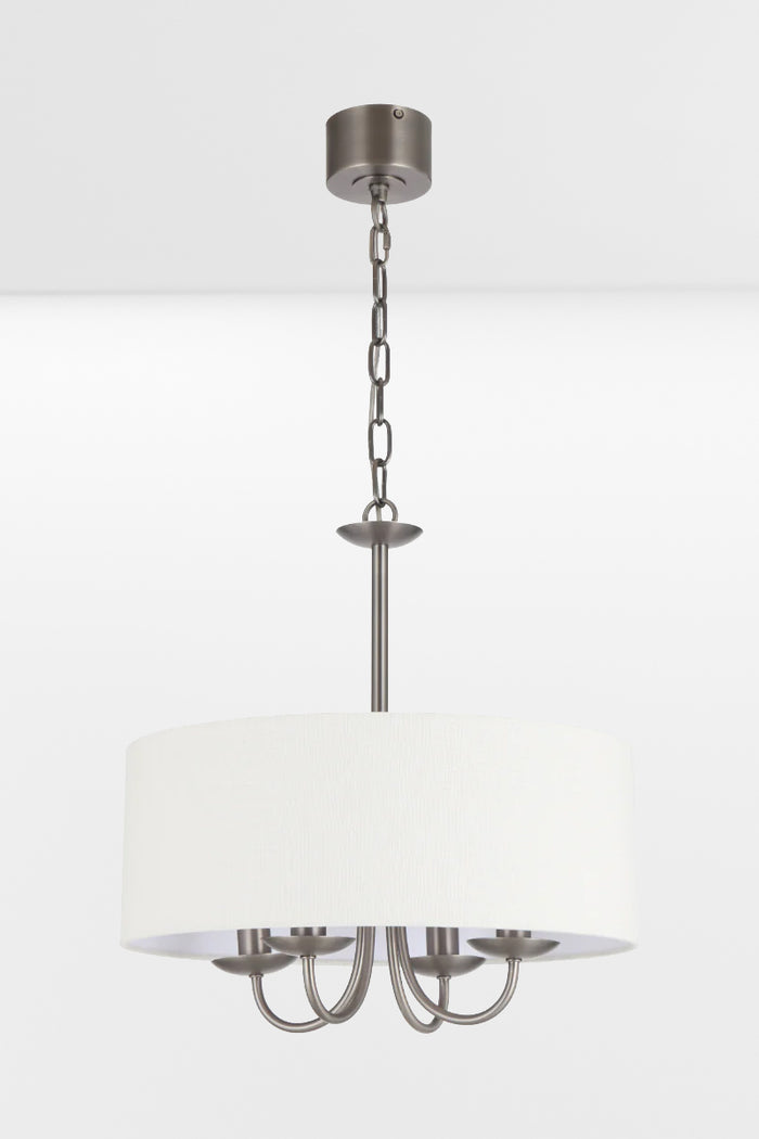 Nickel framed chandelier with four lights and a white fabric drum shade, pictured with lights off.
