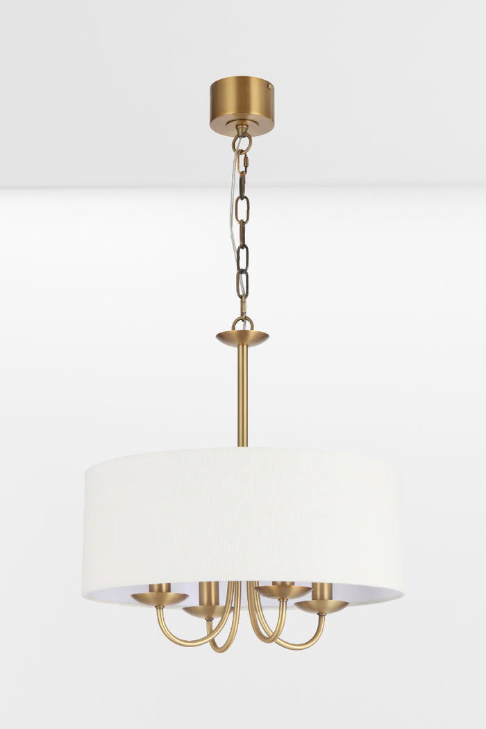 Satin Brass framed chandelier with four lights and a white fabric drum shade, pictured with lights off.