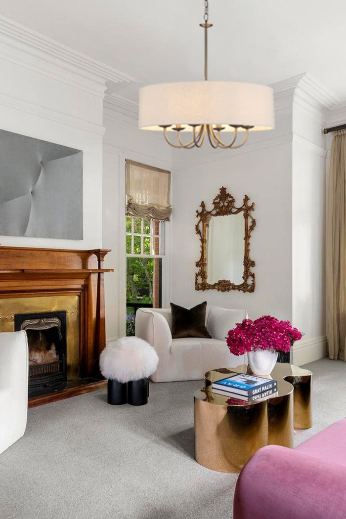 A nickel finished 6 arm chandelier with fabric shade in a designer lounge.