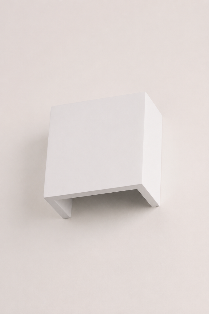 Angled view of the Griffs Plaster Wall Sconce highlighting the clean square profile and crisp white paintable plaster finish.