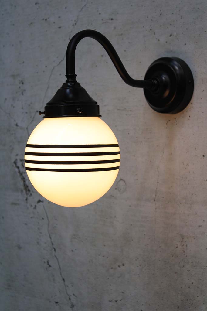 Hand painted opal glass ball pendant light with four stripes on black steel sconce.