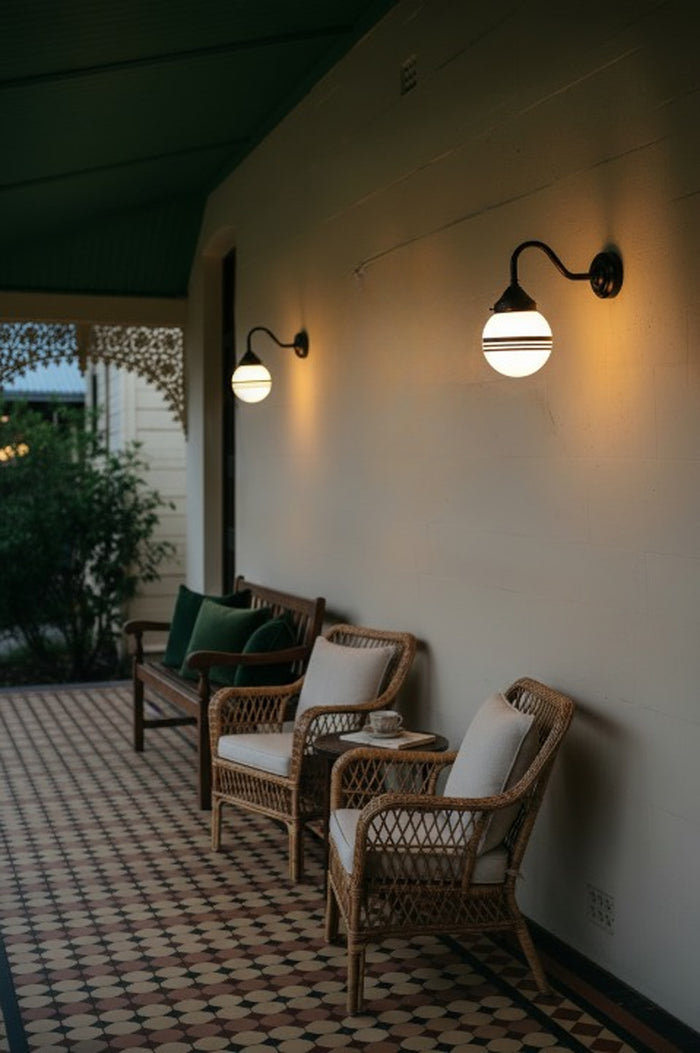 Hand-Painted-Glass-Ball-Gooseneck-Exterior-Wall-Light on the balcony with wicker chairs
