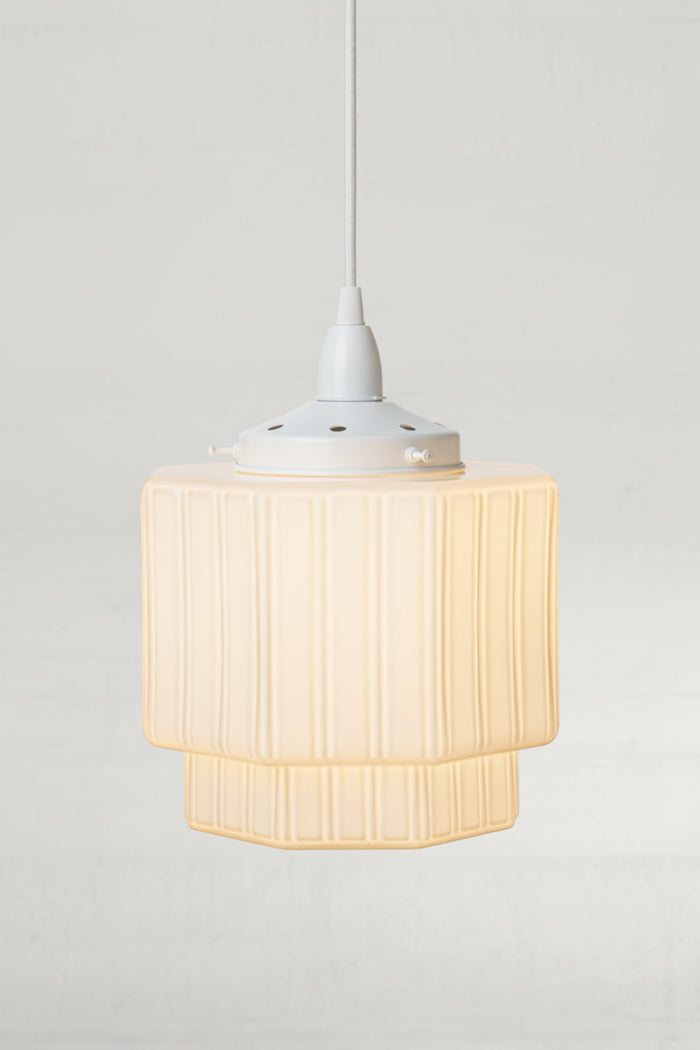 Opal deco shade on a white pendant cord and gallery.