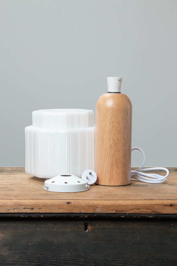 Harcourt Wood Table Lamp with opal glass shade and natural wood base, with shade components displayed beside it.
