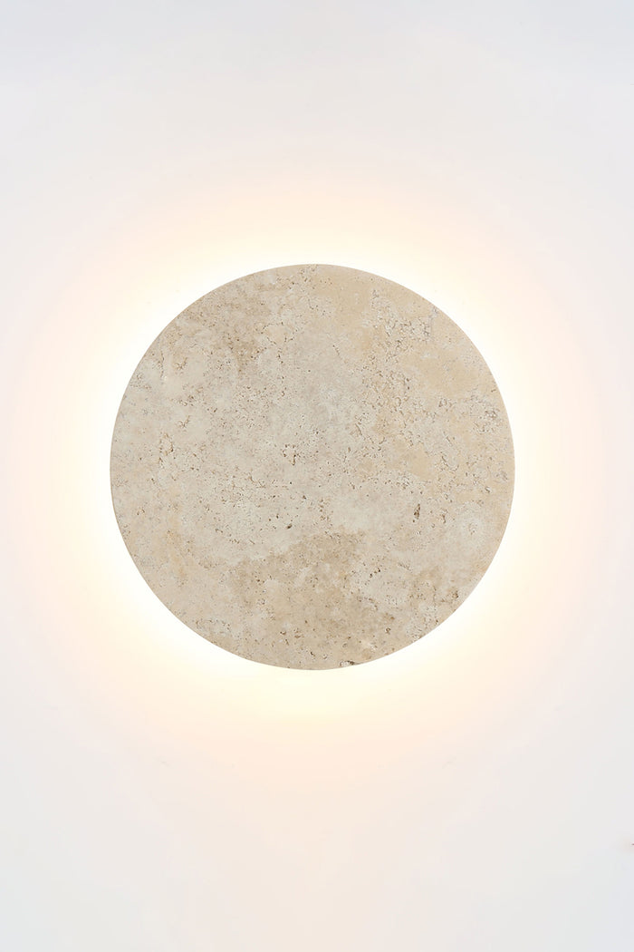 Small travertine circular back-lit LED wall light.