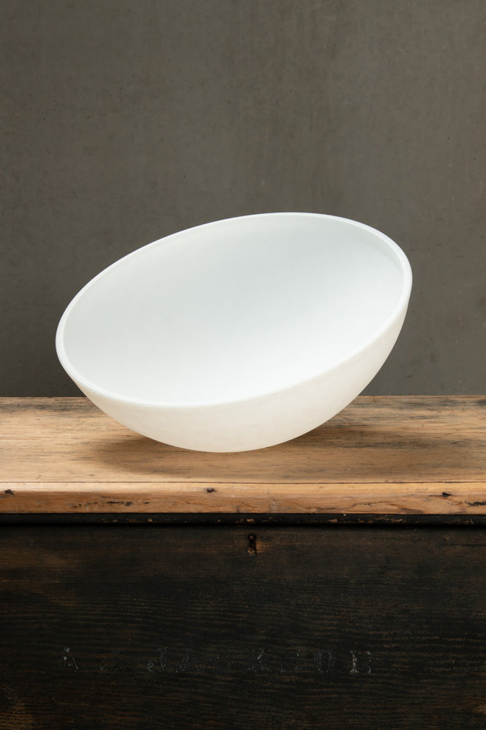 White dome shade for the Homestead Brickworks Pendant Light shown separately on a timber surface