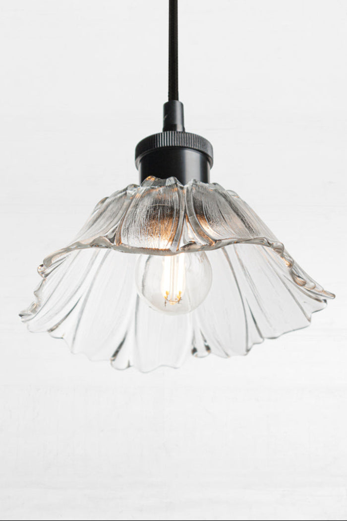 Honfleur clear glass pendant light with decorative fluted shade, black suspension and exposed globe.